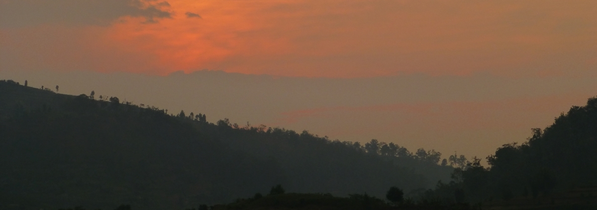 Fishermen row across Lake Kivu at sunrise off the peninsula of Kumbya, Rwanda